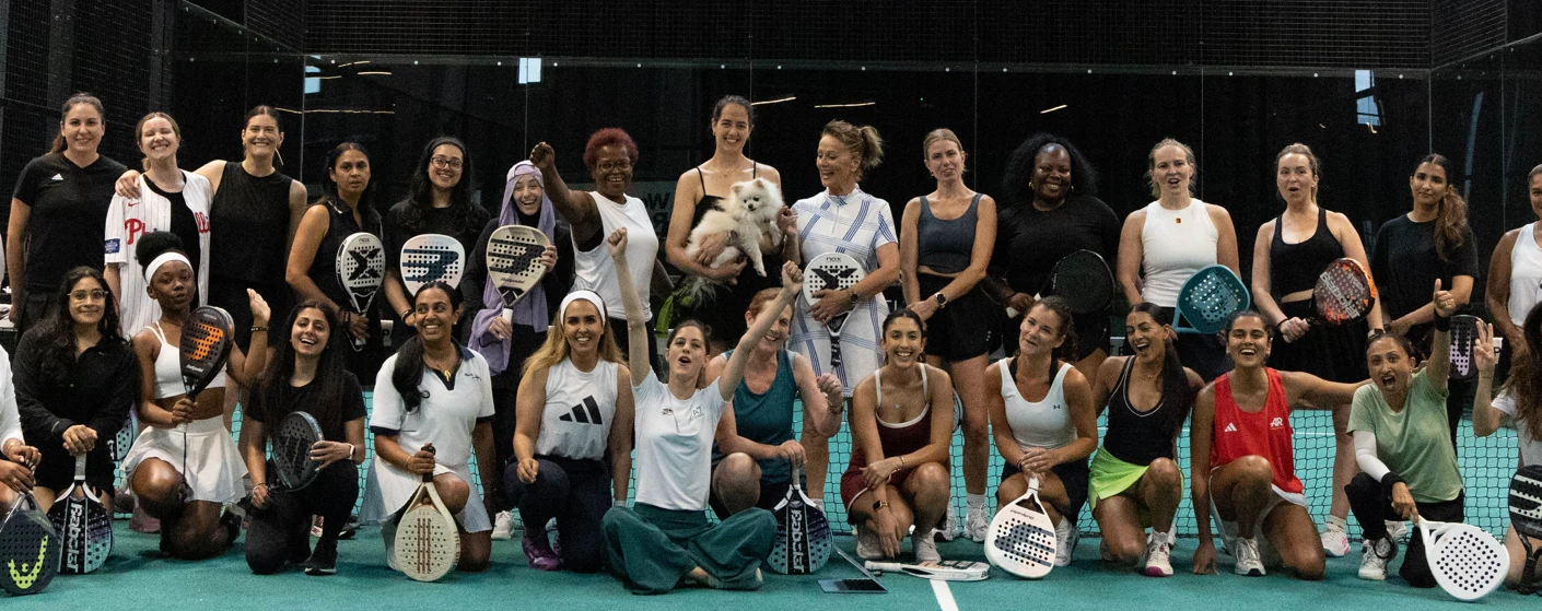 A large group of women on a padel court after playing